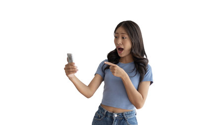 Woman pointing finger at mobile phone, Point to the mobile phone to recommend applying or registering via the smartphone system or scanning the QR code to receive news before anyone else, Click now.の写真素材