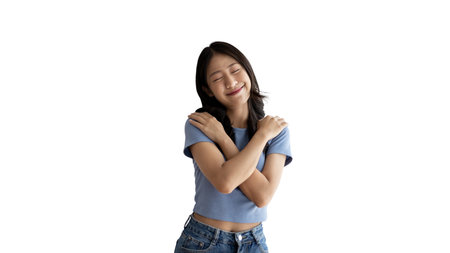 Asian woman smiling happily isolated on white background, Woman loves and rejoices herself, Contented, Pure love, Love myself, Proud of yourself, Self-made happiness, Optimism, Painting Therapy with a smile.の写真素材