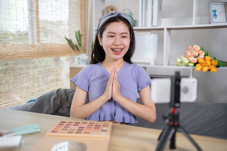 Beautiful woman with a social media influence is greeting the audience for recording vlog video live streaming, Showing how to make up and use cosmetics, Online business on concept of beauty bloggers.の写真素材