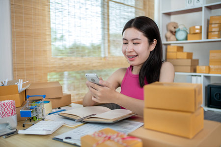 Woman uses a mobile phone to chat with customers who come to order product, Freelance work at home,...