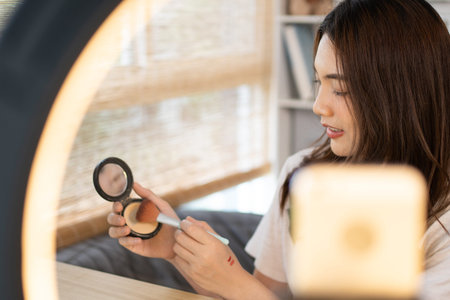 Beautiful women with social media influences are teaching makeup and use cosmetics, In front of the...