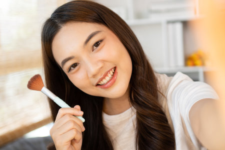 Beautiful woman with a social media influence is greeting the audience for recording vlog video live streaming, Showing how to make up and use cosmetics, Online business on concept of beauty bloggers.の写真素材