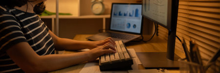 Late-Night Online Education, Dedicated Young Woman Studying Online Late at Night in Her Home Office,...
