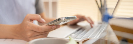 Sell products online, Woman Multitasking: Typing on Laptop and Send a message on your mobile phone...