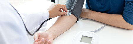 Female doctors use blood pressure monitors and stethoscope to measure pulse Diagnose the patient's...