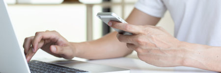 Men use smart phone to register online purchases using credit card payments, Convenience in the...