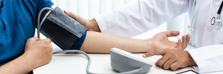 Female doctors use blood pressure monitors and stethoscope to measure pulse Diagnose the patient's disease in a modern hospital medical laboratory, Medical treatment and health care concept.の写真素材