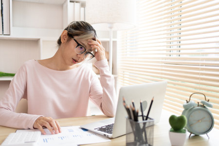 Stressed Businesswoman Facing Financial Loss in Corporate Office, Depressed man Dealing with Financial Setback, Stress and Money Problems, Anxiety and Worry Concept.の写真素材