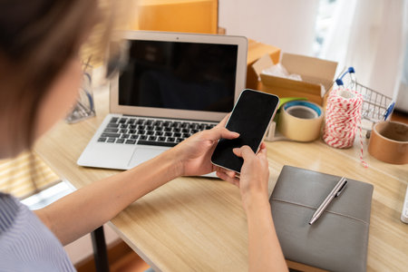Sell products online, Young woman typing chat or message on mobile phone with smiling face, Digital Communication, Conversation via smartphone of internet network.の写真素材