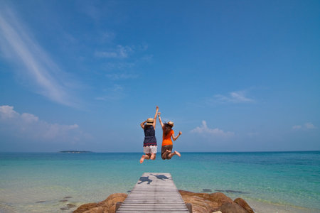 Jumping on the beach, Munnork Island, Rayong Province, Gulf of Thailandの写真素材