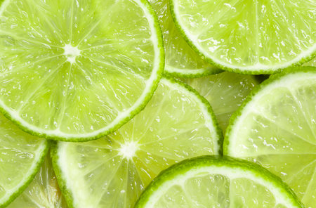 Fresh juicy lime slices as background, top viewの写真素材