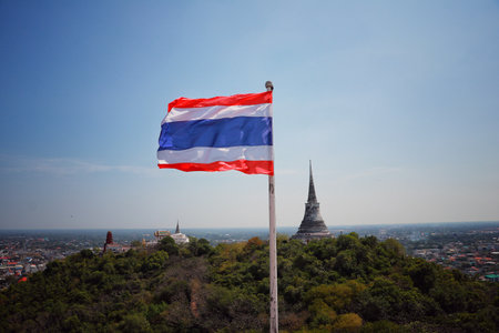 Thai flag with Phra Nakhon Khiri view (Khao Wang) in Phetchaburi province, Thailandの写真素材