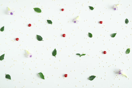 Pattern with the little green leafs, red seeds and violet flowers on white background, lay flat and...