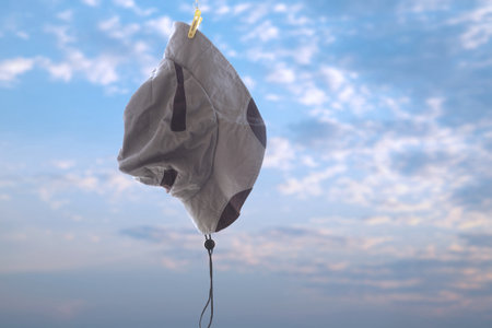 Hat hangigng on clothspin with blue sky background, mean it's time for break after travel.の写真素材