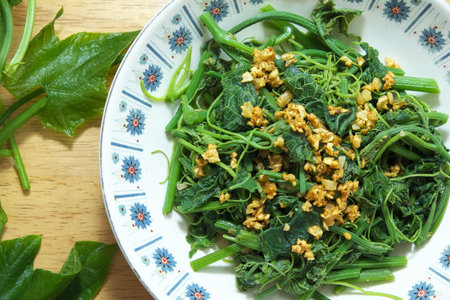 Stir fried green Chayote with  fried garlic, on wooden table.の写真素材