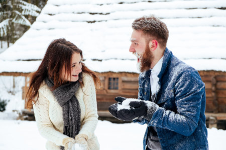 Happy Young Couple in Winter Park having fun.Family Outdoors