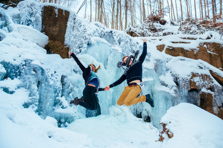 happy loving couple walking in snowy winter forest, Outdoor seasonal activities. Lifestyle capture.の写真素材