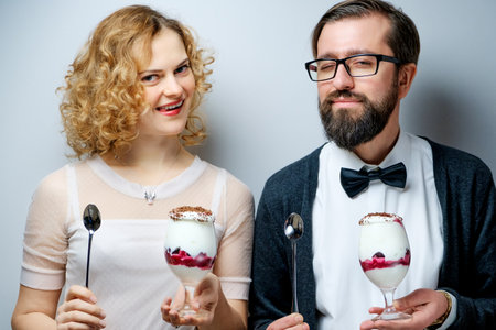 Loving couple eating cherry ice cream togetherの写真素材