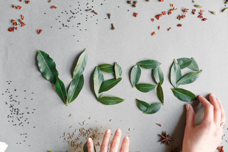 Word vegetarianism on a white background of leafs and spices top viewの写真素材