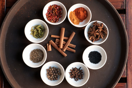 Many different spices on white platesの写真素材