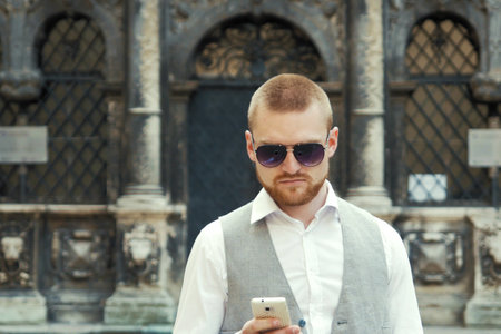 Man on smartphone - young business man talking on smart phone.の写真素材