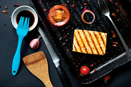 ofu on the grill on the table on a black background, view from the top.の写真素材