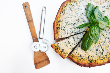Homemade cake with short bark beetroot with tofu and spinach decorated with basil leaves. on a white backgroundの写真素材