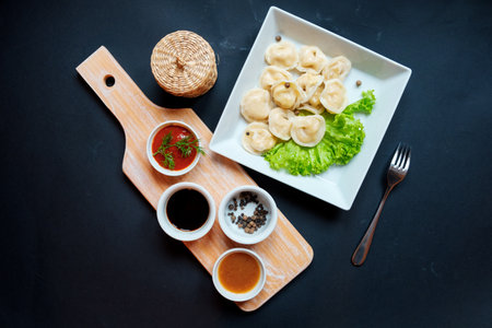 Dumplings raw on a wooden board. Vegeterian food. The process of cooking dumplings.の写真素材