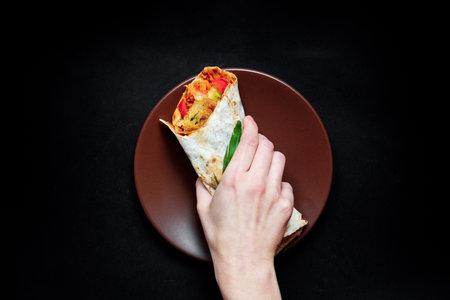 Vegan burger with sliced fresh vegetables on a dark background.の写真素材