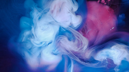 Blue pink clouds of ink in liquid. black background