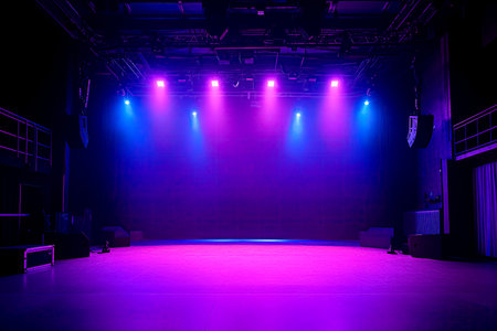 an empty and eclectic performance stage in dim purple and blue lighting rigの素材