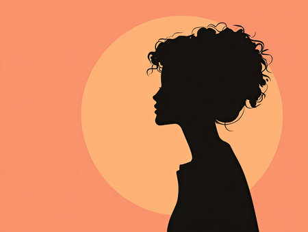 Dark silhouette of curly haired woman with orange circleの素材