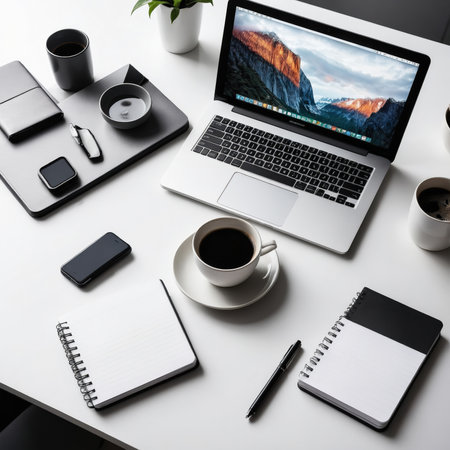 Top view of modern workplace with laptop, coffee cup and other itemsの素材