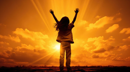A silhouette of a little child reaching out to grab stars, Expresses the ambition, The joy of a small child with dreams. Kid having fun at sunset. Summer vacation and travel concept.の素材