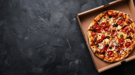 delicious pizza in a cardboard box on a dark chalkboard, creating an appetizing top viewの素材