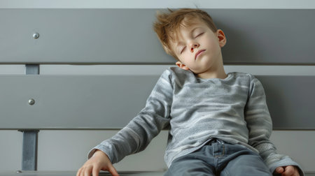 Rest needed: Child slumps on bench, eyes closed in exhaustion.の素材