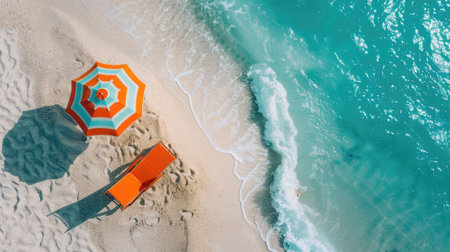 A vibrant orange beach chair stands elegantly beside a matching umbrella on a sandy beach, welcoming relaxation and serenity.の素材