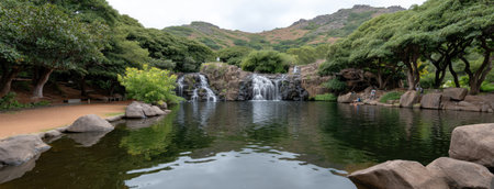 Deep in the jungle of El Yuc_phon, clear water cascades gracefully over rocks into a serene pool, creating a peaceful atmosphere amidst vibrant greenery and natural beauty.の素材