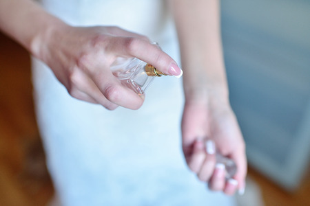 Beautiful wedding perfume bottle for bride and groom. Beauty of wedding accessories indoors. Close-up bridal jewellery and perfumery. Female and male jewel. Jewelry for man and womanの写真素材