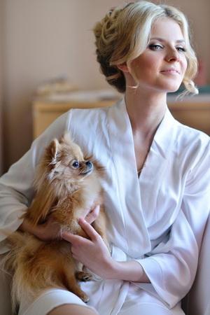 Beauty Bride In Dressing Gown With A Cute Dog Indoors