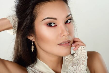 Female portrait of cute lady isolated on a white background. Close up beautiful sexy model girl in elegant pose. Closeup beauty brunette woman with hairstyle indoorsの写真素材