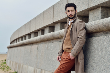 Handsome groom in coat in the nature. Male portrait in the park. Beautiful model boy in colorful wedding clothes. Man is posing. Handsome guy outdoorsの写真素材