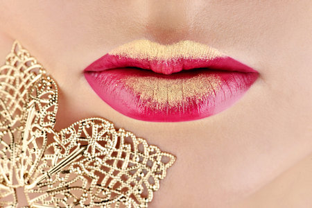 Fashionable model girl with perfect bright color makeup. Closeup beautiful woman with red glossy...