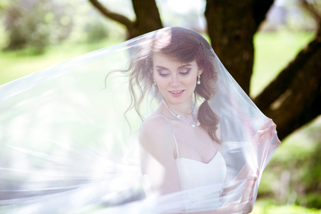 Blonde bride in fashion white wedding dress with makeupの写真素材