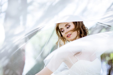 Blonde bride in fashion white wedding dress with makeupの写真素材