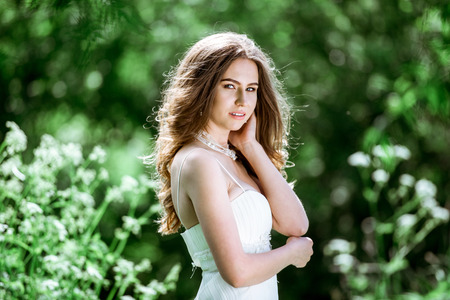 Brunette bride in fashion white wedding dress with makeupの写真素材