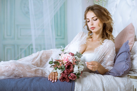 Beautiful sexy lady in elegant white robeの写真素材