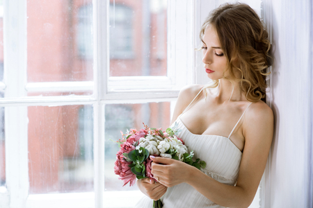 Brunette bride in fashion white wedding dress with makeupの写真素材