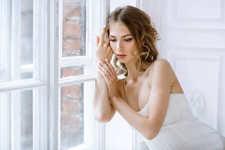 Brunette bride in fashion white wedding dress with makeupの写真素材