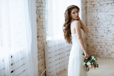 Brunette bride in fashion white wedding dress with makeupの写真素材